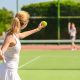 jogadora de tenis em quadra segurando a bola